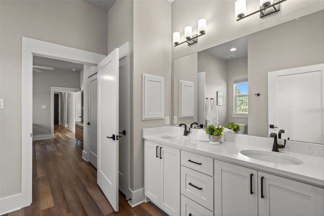 Full bathroom with double vanity, wood finished floors, and baseboards | Image 21