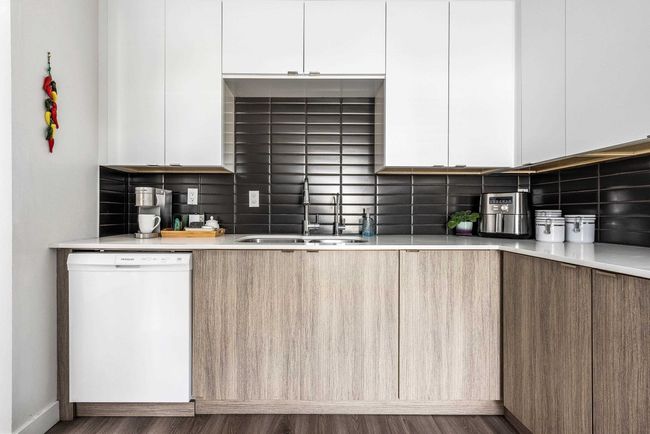 Kitchen featuring dishwasher, modern cabinets, and a sink | Image 8