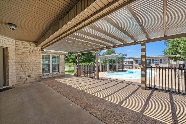 View of patio / terrace featuring a pergola, fence, and a fenced in pool | Image 29