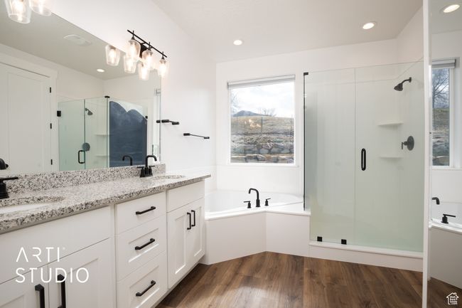 Bathroom with hardwood / wood-style flooring, vanity, separate shower and tub, and a wealth of natural light | Image 23