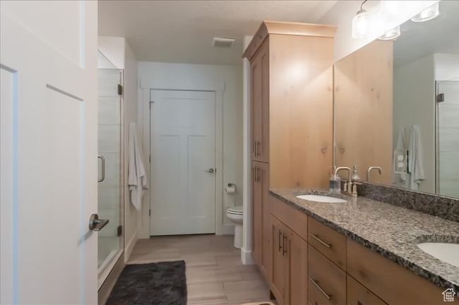 Full bath with double vanity, a stall shower, and toilet | Image 19