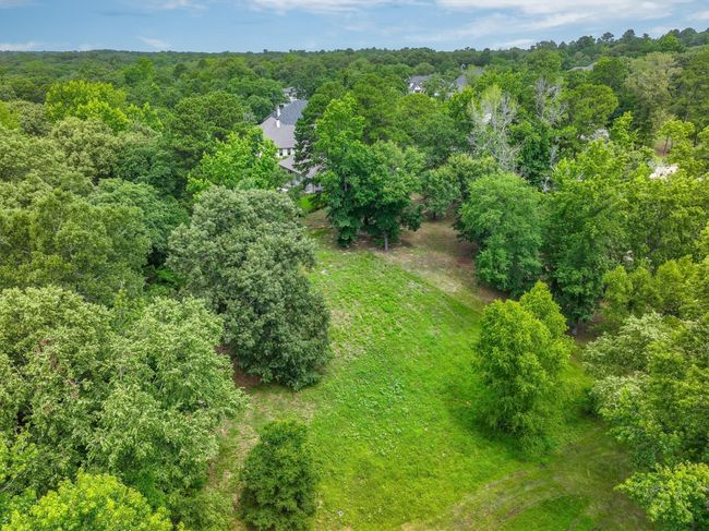 Aerial view of property's location featuring a heavily wooded area | Image 8