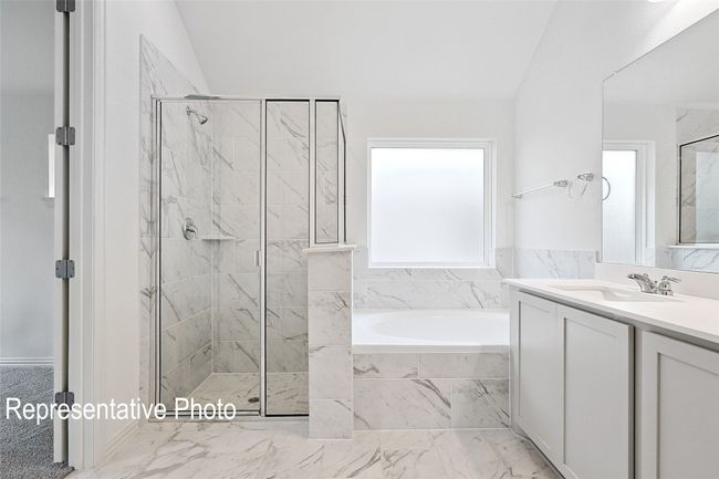 Bathroom featuring a bath, marble finish floor, vanity, and a marble finish shower | Image 11