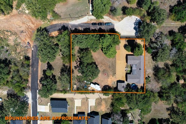 This view shows the home as it sits in the neighborhood. The outline portion shows the home with the 5 lots. From the left edge of the orange line to the road on the left would be the two 50' by 150' lots. If you purchase all of this, you would own this whole corner which is just under an acre of land. | Image 10