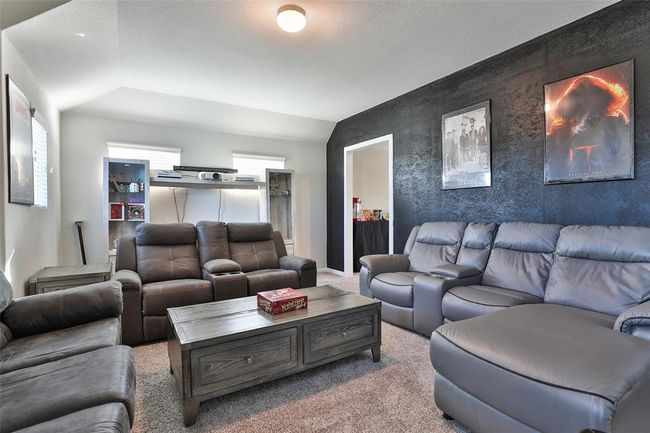The black accent wall adds a truly unique touch, blending seamlessly in this versatile hybrid room. | Image 20