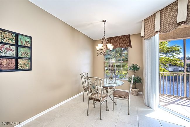 Tiled dining area featuring a water view and an inviting chandelier | Image 26