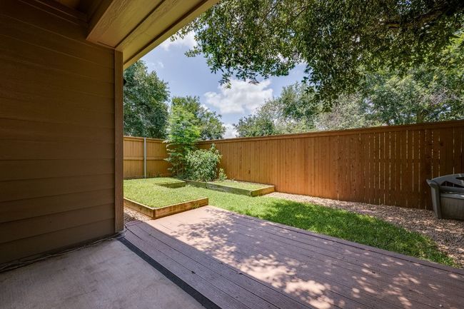Wooden terrace with a fenced backyard | Image 34