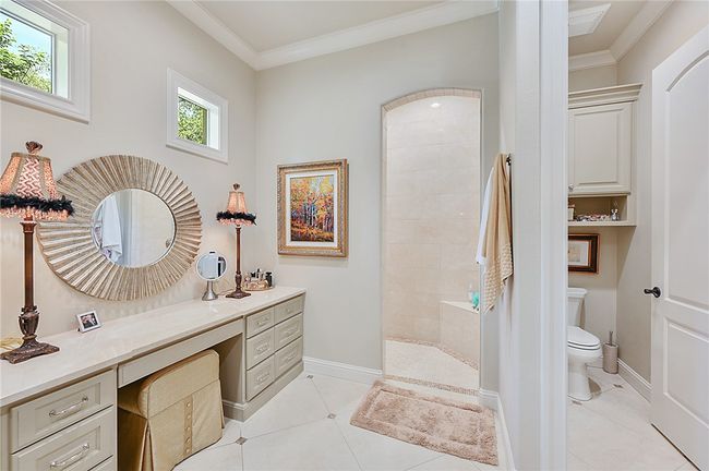 Bathroom with toilet, ornamental molding, walk in shower, vanity, and tile patterned floors | Image 12