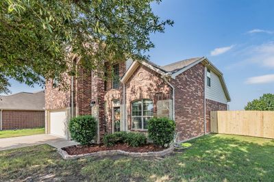 View of front of home with a front yard and a garage | Image 1