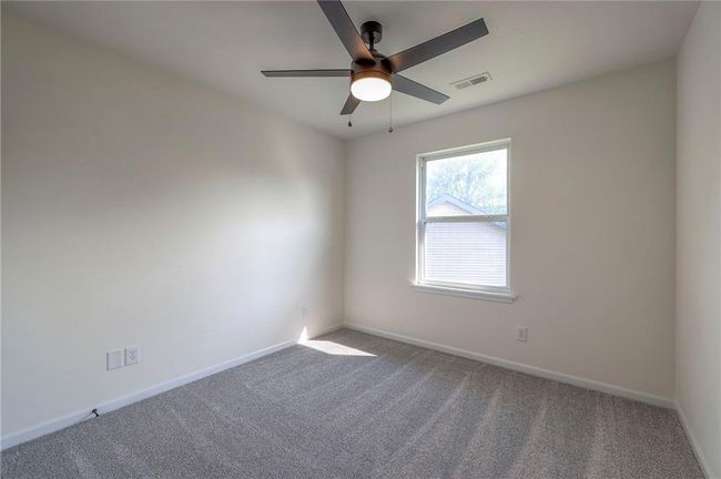 Carpeted empty room featuring baseboards and ceiling fan | Image 18