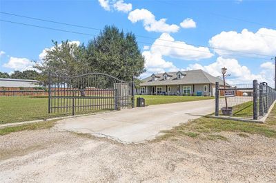 View of gate featuring a lawn | Image 3