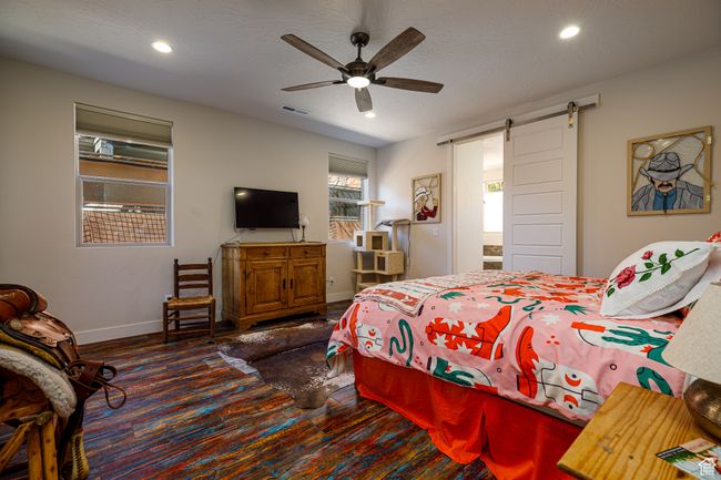 Primary Bedroom with recessed lighting, baseboards, a barn door to En-Suite Bath, ceiling fan | Image 19