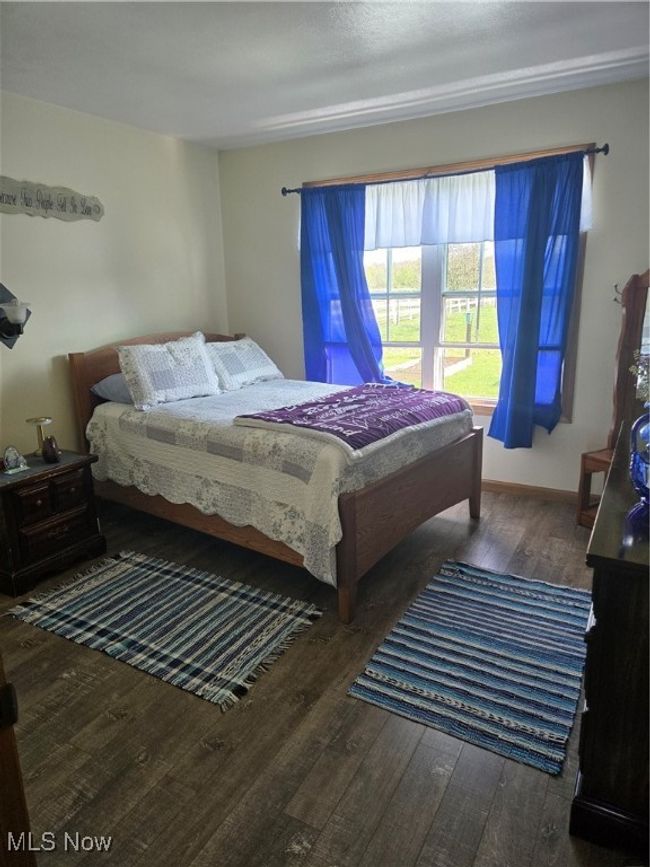 Bedroom with hardwood / wood-style floors | Image 37