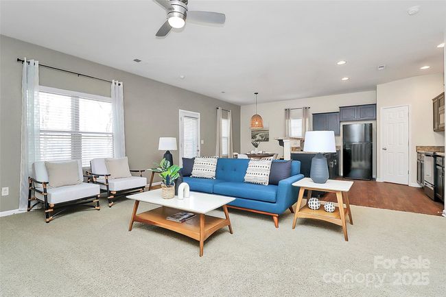 Living room view showing open flow to kitchen & dining area. | Image 5