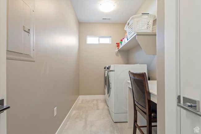 Laundry area featuring washing machine and clothes dryer and baseboards | Image 27