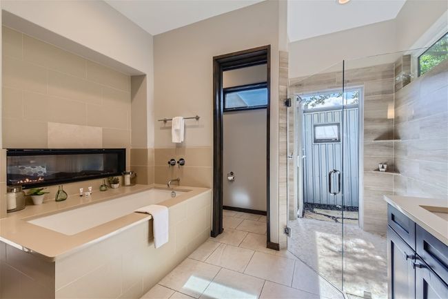 Full bathroom with a garden tub, a shower stall, tile walls, and tile patterned floors | Image 7