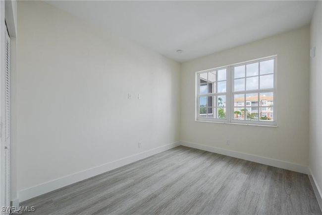 Empty room featuring baseboards and wood finished floors | Image 12