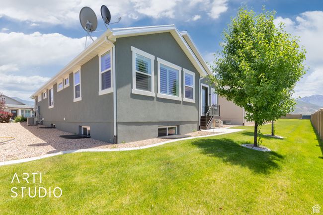 View of side of home with a central air condition unit | Image 38