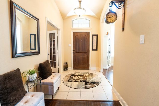 Tiled foyer with vaulted ceiling and baseboards | Image 5