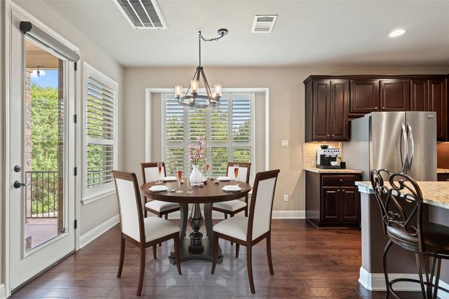 Breakfast space featuring a chandelier, dark wood finished floors, and recessed lighting | Image 12