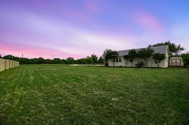 View of yard with a storage shed, an outdoor structure, and fence | Image 18