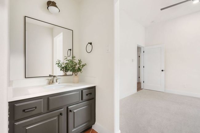Clean, neutral tile and updated lighting give the guest bathrooms a fresh, timeless feel that blends seamlessly with any style. | Image 24