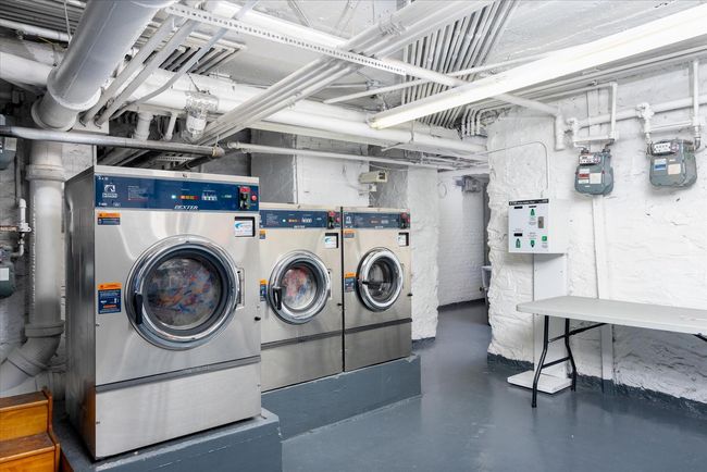 Common laundry area featuring washer and clothes dryer | Image 11