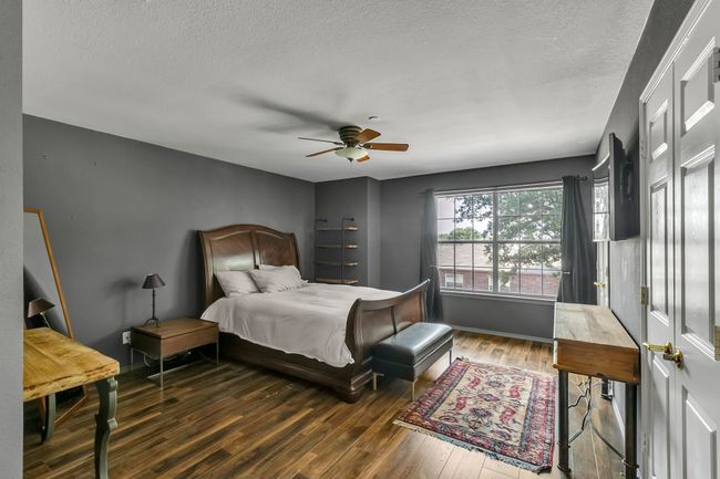 Bedroom with wood finished floors, a textured ceiling, and a ceiling fan | Image 18