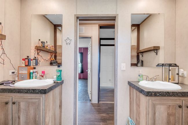 Bathroom featuring wood finished floors, two vanities, and a sink | Image 32