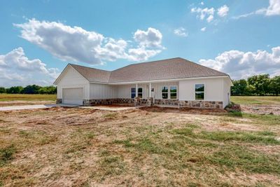 Back of property featuring a garage | Image 1