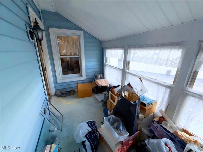 Sunroom / solarium featuring lofted ceiling | Image 25