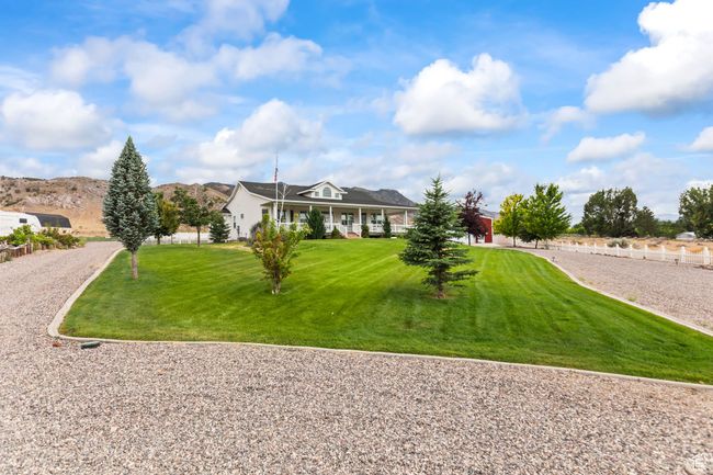 View of front of house with a front lawn, covered porch, and a mountain view | Image 96