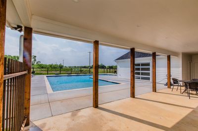 View of pool from covered patio area | Image 2