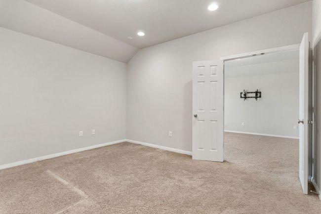 Carpeted spare room with baseboards, lofted ceiling, and recessed lighting | Image 40