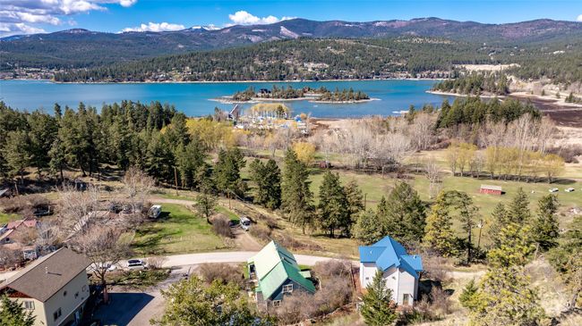 Drone / aerial view featuring a wooded view and a water and mountain view | Image 57