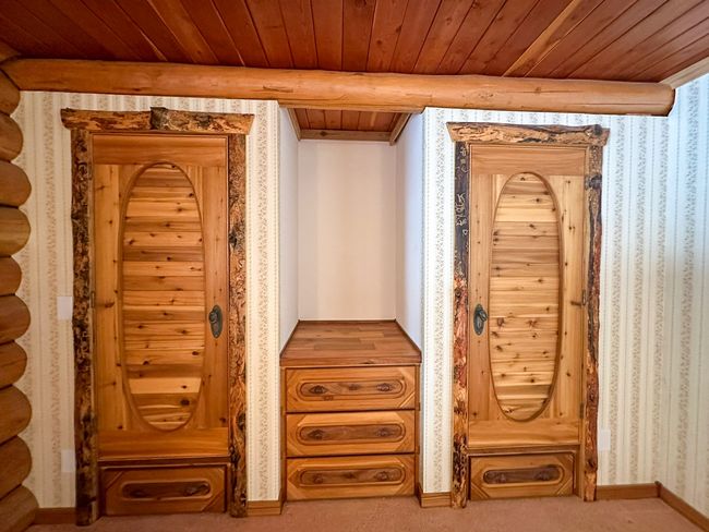 Interior details featuring beam ceiling, wooden ceiling, and carpet flooring | Image 34