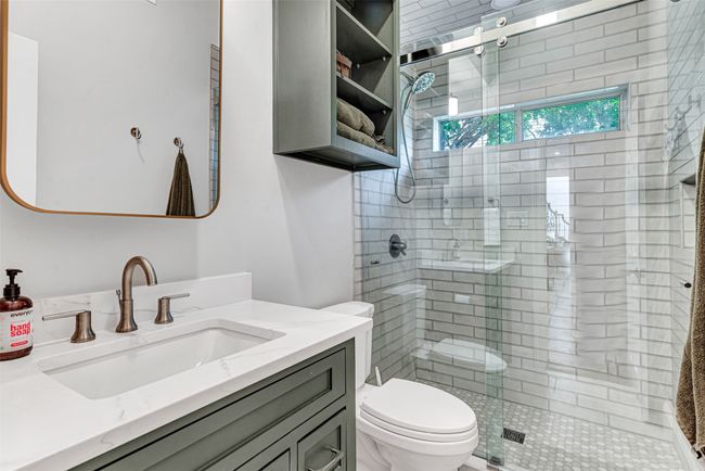 Exquisitely updated full bath downstairs adjacent to the first floor guest bedroom, home office, or craft room! | Image 31