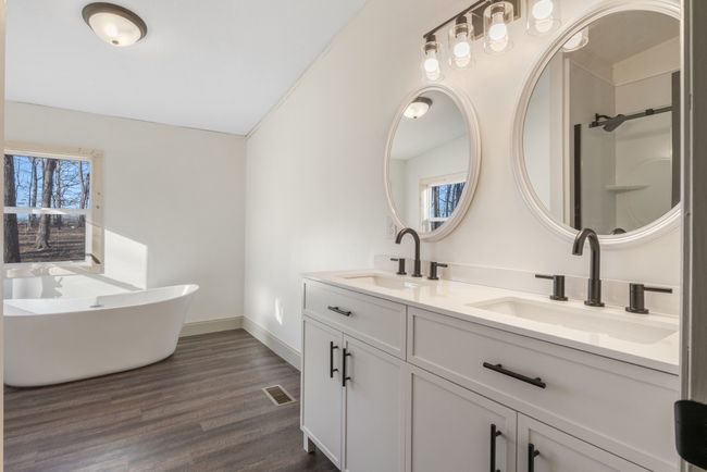 The dual vanity in the primary suite offers plenty of space, making mornings easier and more convenient. With updated fixtures and a stylish design, it adds both functionality and a touch of elegance to the en-suite bath. | Image 15