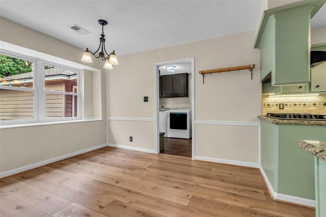 Light-filled breakfast room with a view of the backyard. | Image 14