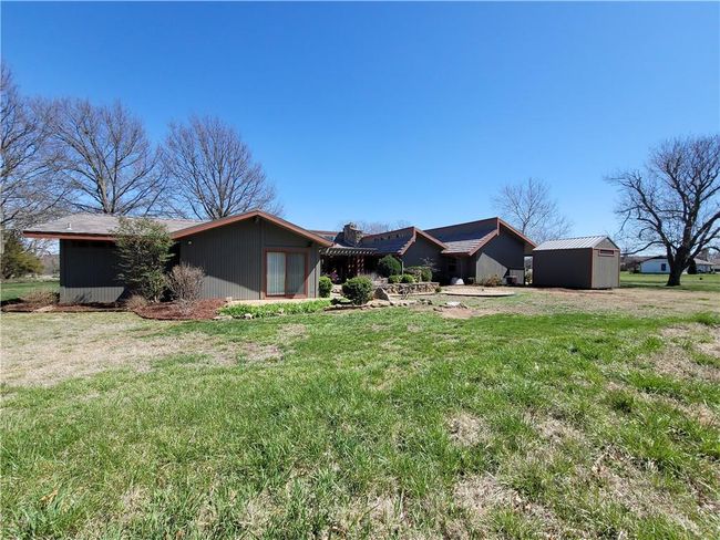 View of front of property with an outdoor structure, a front yard, and a storage shed | Image 68
