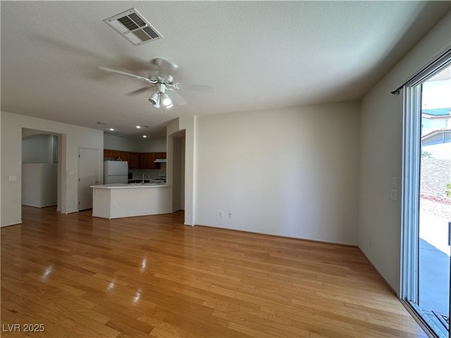 Unfurnished living room featuring light wood-style floors, a ceiling fan, and a textured ceiling | Image 10