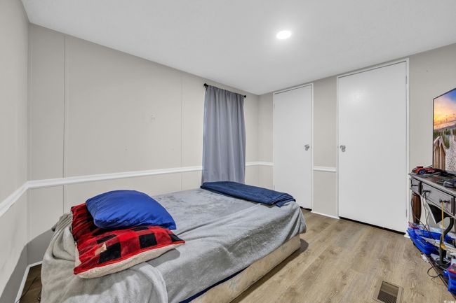 Bedroom featuring wood finished floors | Image 17