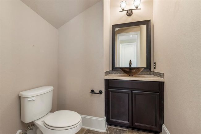 Guest bath down is spacious with a pretty vessel sink. | Image 34