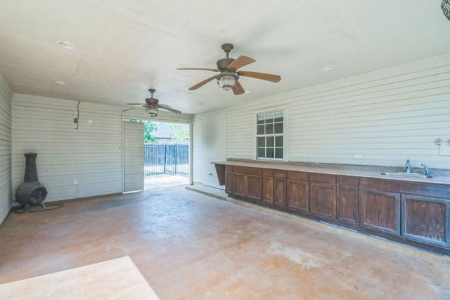 View of patio with a ceiling fan and a sink | Image 25