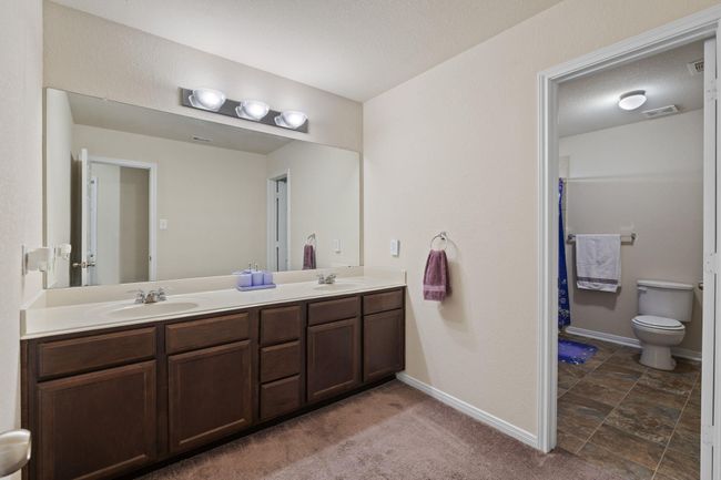 The large upstairs secondary bathroom has a separate sink area from the shower/tub. | Image 34