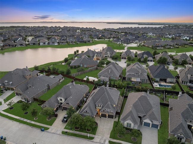 Located in The Tribute, a premier lakeside resort-style community, this home offers amenities for the entire family — including pools, pickleball courts, trails, and more! | Image 4