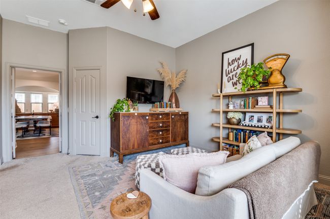 Yes, this is still the primary bedroom with its very own living space! Ceiling fan, window seat and double doors leading to main living spaces! | Image 10