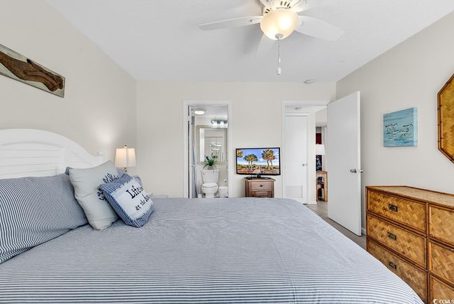 Bedroom with ceiling fan and ensuite bath | Image 17