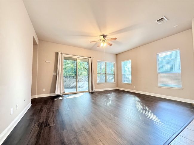 Unfurnished room featuring a ceiling fan and dark wood finished floors | Image 5