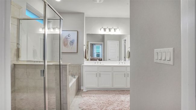 Full bath with vanity, tile patterned flooring, a bath, and a stall shower | Image 18